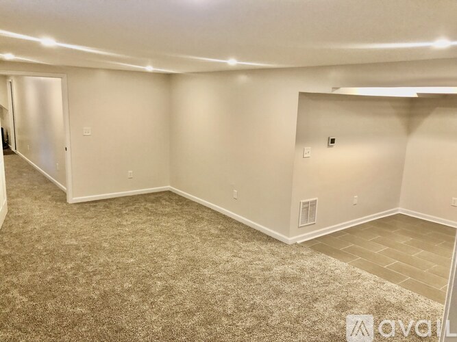 A room with carpeted flooring and white walls.