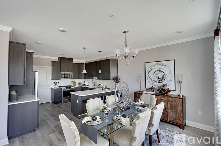A modern kitchen with a dining table set for four.