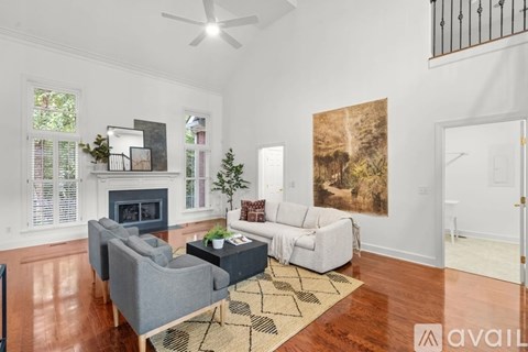 A living room with a grey couch and a fireplace.