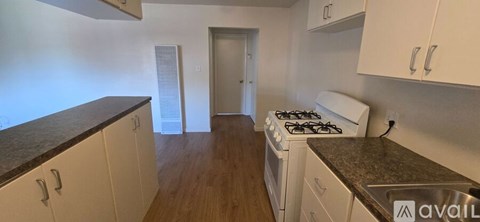 A kitchen with a stove and cabinets.