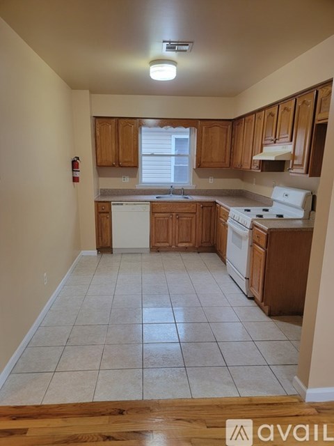A kitchen with wooden cabinets and white appliances.