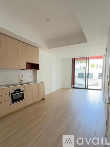 A kitchen with wooden cabinets and a stainless steel countertop.