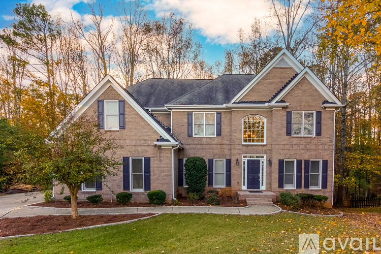 A house with a brick facade and a large front yard.
