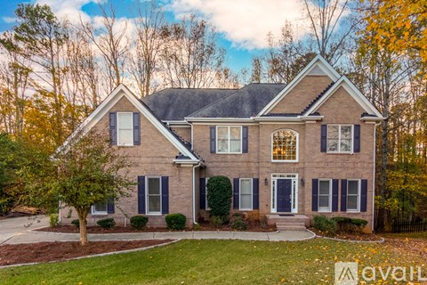 A house with a brick facade and a large front yard.