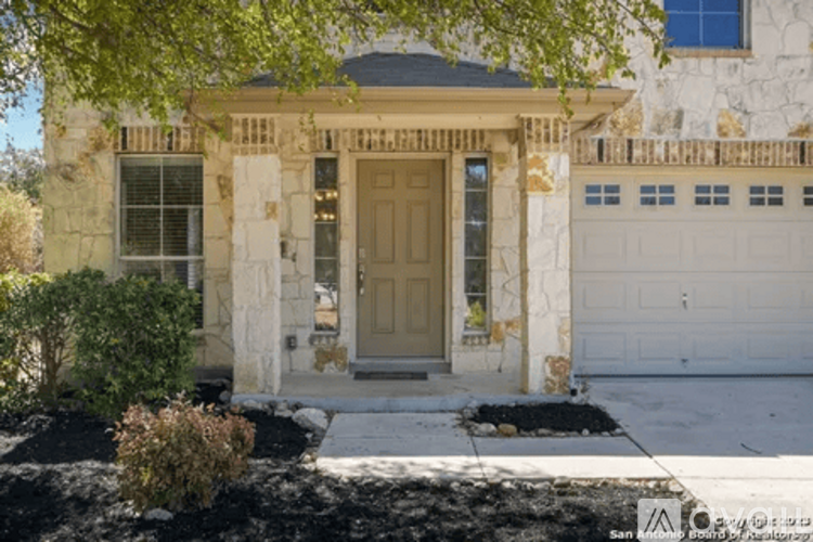 A house with a brown door and a stone wall.