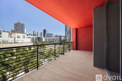 A balcony with a view of the city skyline.