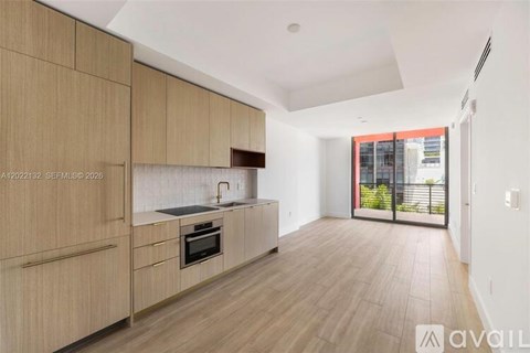 A kitchen with wooden cabinets and a countertop with a sink.