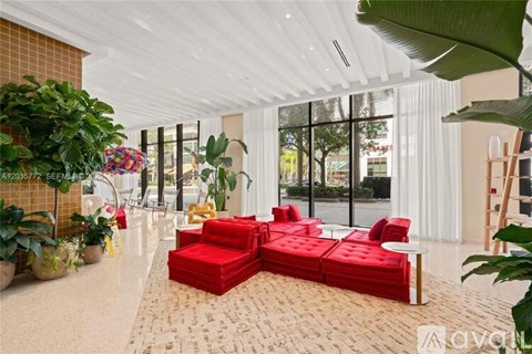 A living room with red couches and a white ceiling.