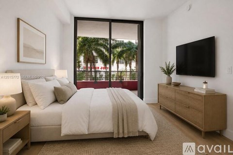 A bedroom with a large bed, a television, and a window overlooking a city street.