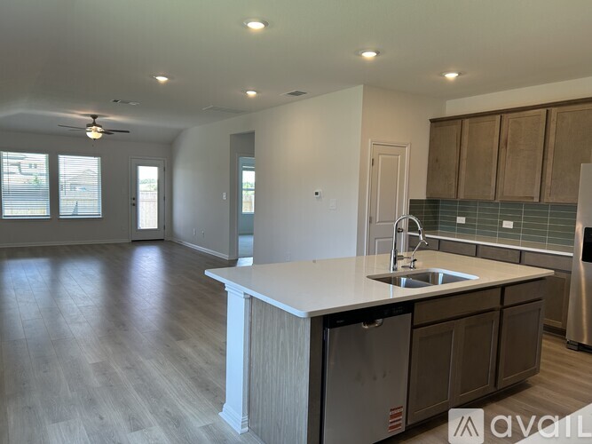 A kitchen with a white countertop and wooden cabinets.