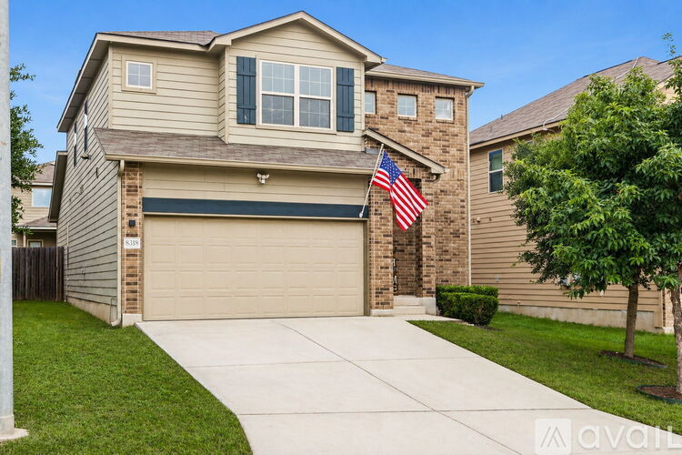 A house with a garage and an American flag hanging on the wall.