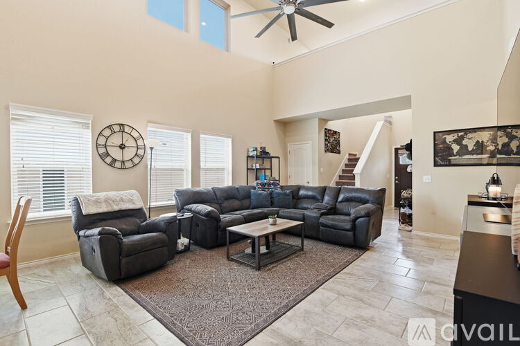 A living room with a large sectional sofa and a coffee table.
