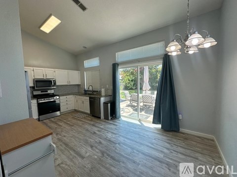 A kitchen with a dining table and chairs is available for rent.