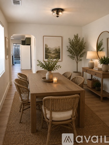 A dining room with a wooden table and chairs.