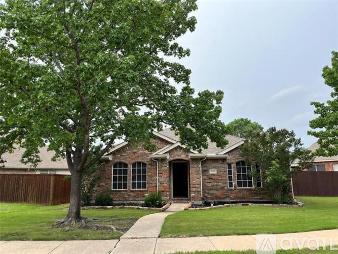 A house with a tree in front of it.