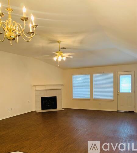 A living room with a fireplace and a chandelier.