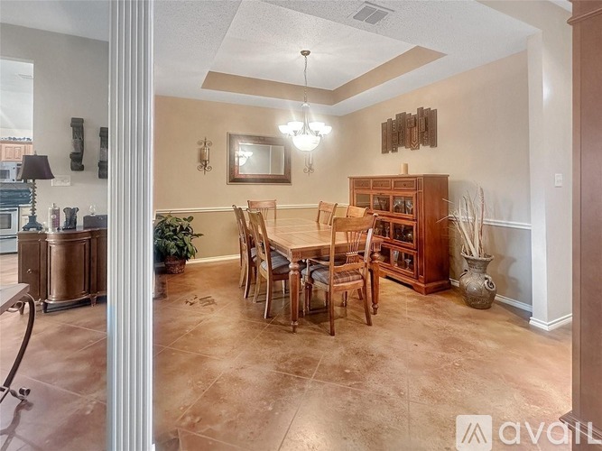 A dining room with a table set for four.