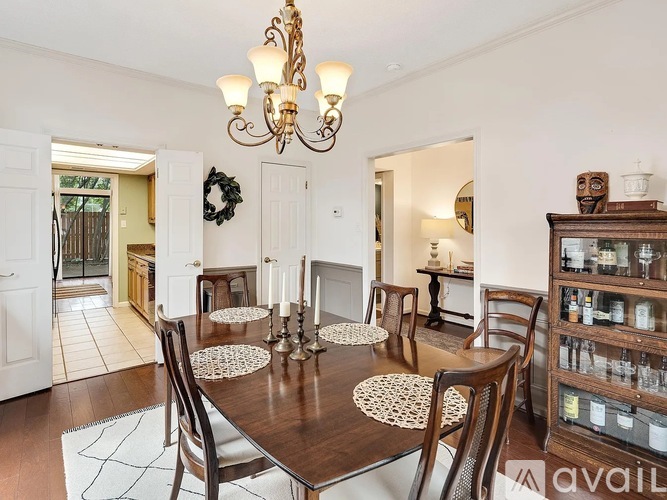 A dining room with a wooden table and chairs.