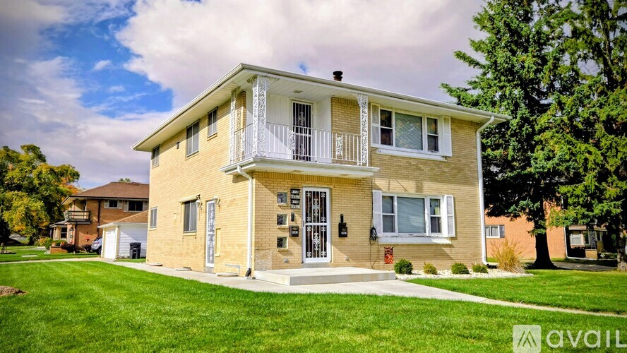 A two-story house with a balcony on the second floor.