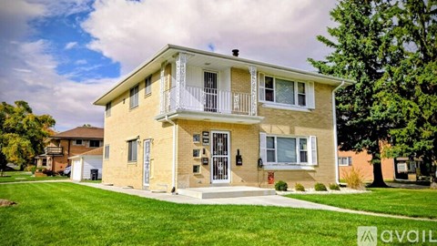 A two-story house with a balcony on the second floor.
