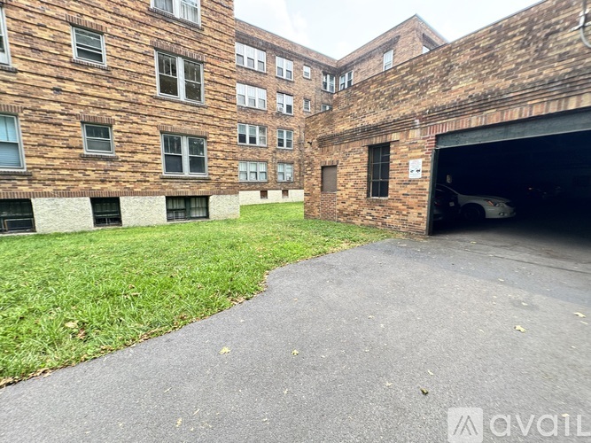 A brick building with a garage door open.
