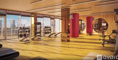 A gym with a view of the city outside the windows.