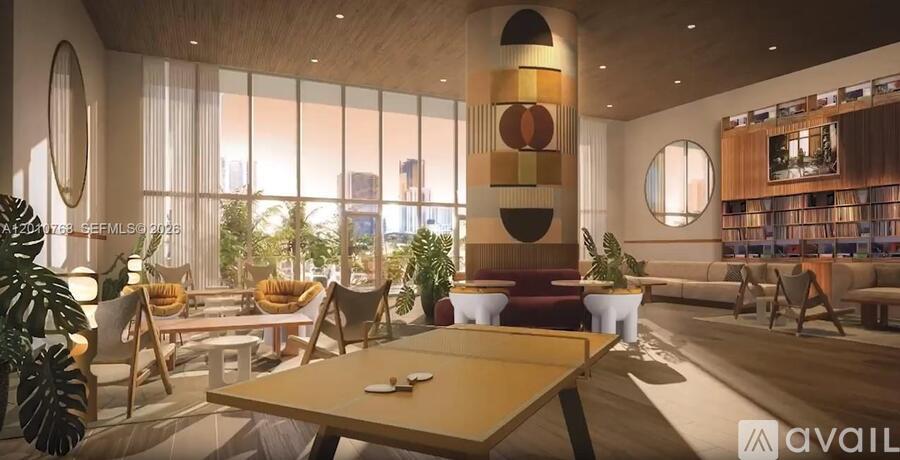 A modern living room with a pool table and a bookshelf.