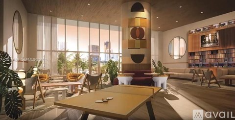 A modern living room with a pool table and a bookshelf.