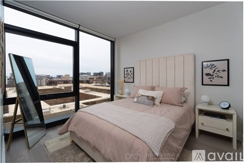 A bedroom with a large bed and a view of the city.