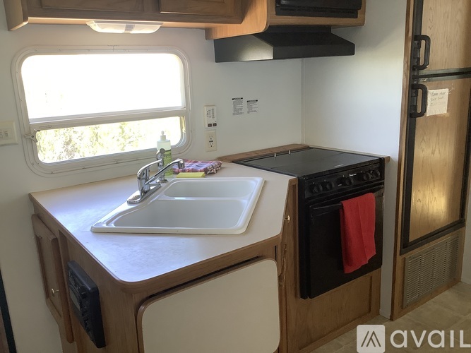 A small kitchen with a sink and stove.