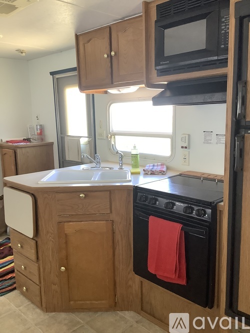 A kitchen with a black oven and a white sink.