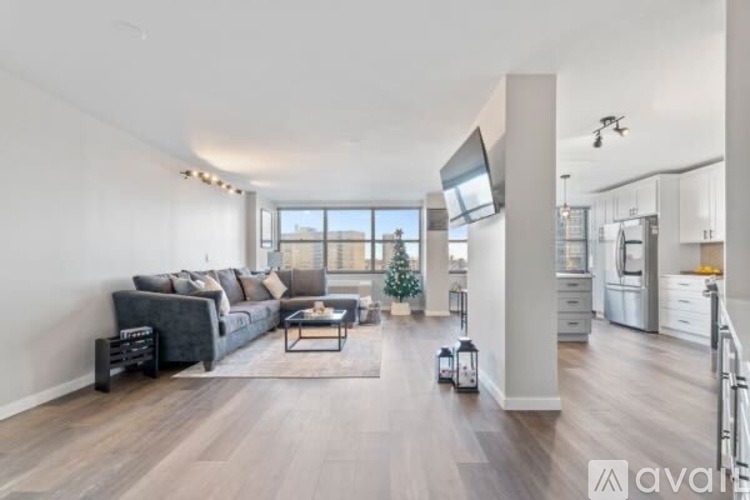 A modern living room with a grey sofa and a coffee table.