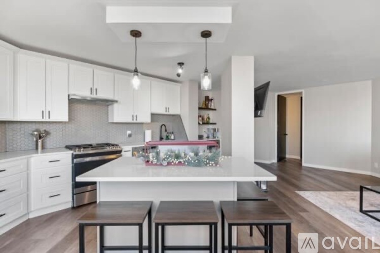 A modern kitchen with white cabinets and a central island.
