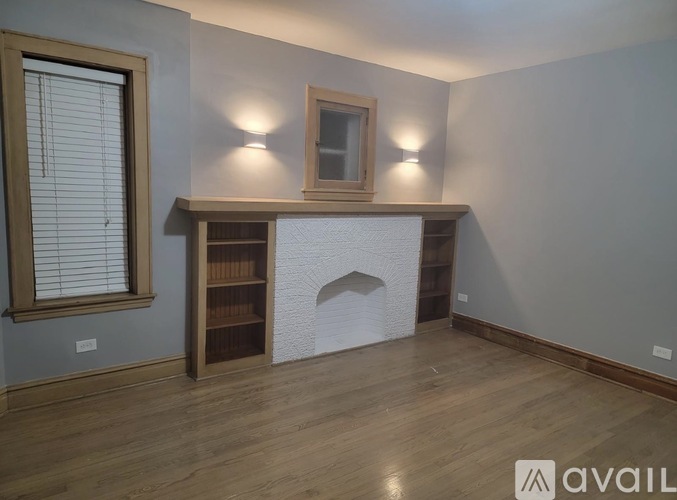 A room with a fireplace and a bookshelf.