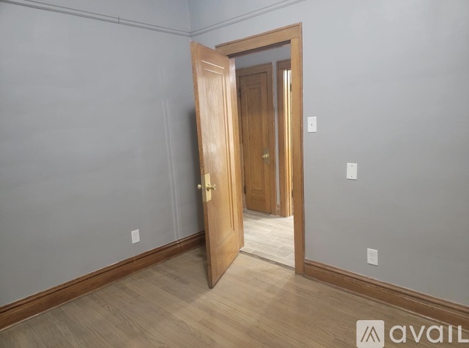 A room with a wooden door and a wooden floor.