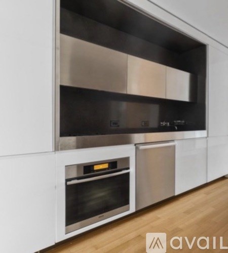 A modern kitchen with stainless steel appliances and white cabinets.