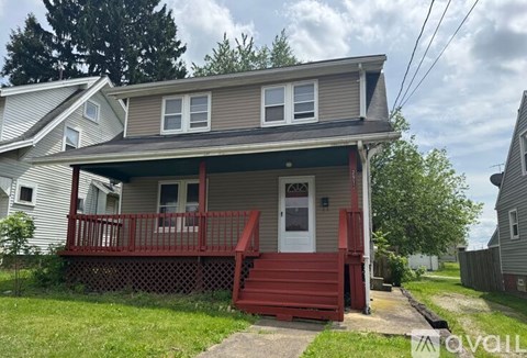 A house with a red staircase leading to the front door.