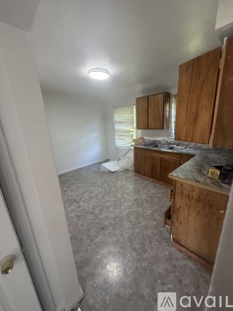 A kitchen with wooden cabinets and a granite countertop.