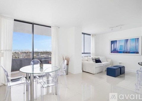 A modern living room with a glass table and white furniture.