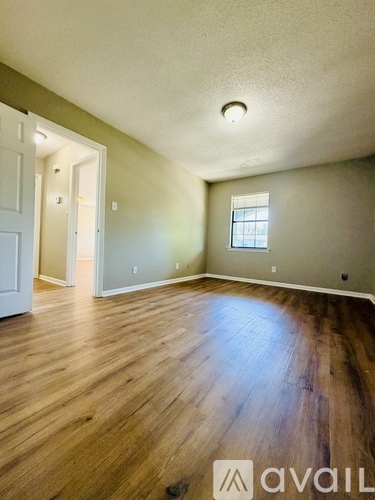 A room with wooden floors and a window.