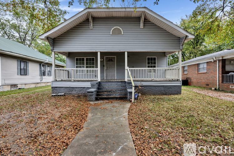 A house with a front porch and a covered walkway.