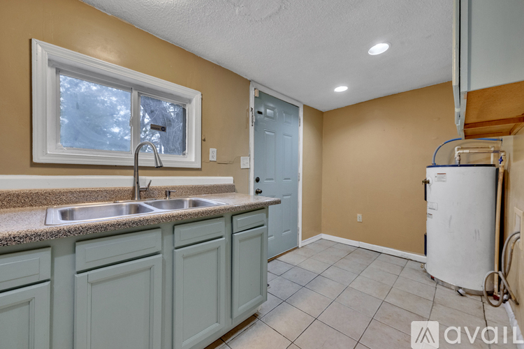 A kitchen with a sink and a window.