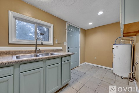 A kitchen with a sink and a window.