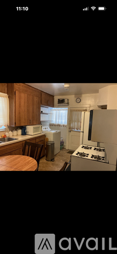 A kitchen with wooden cabinets and a white stove top oven.