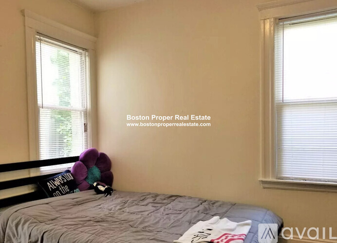 A bedroom with a bed, pillows, and a sign that says "Available".