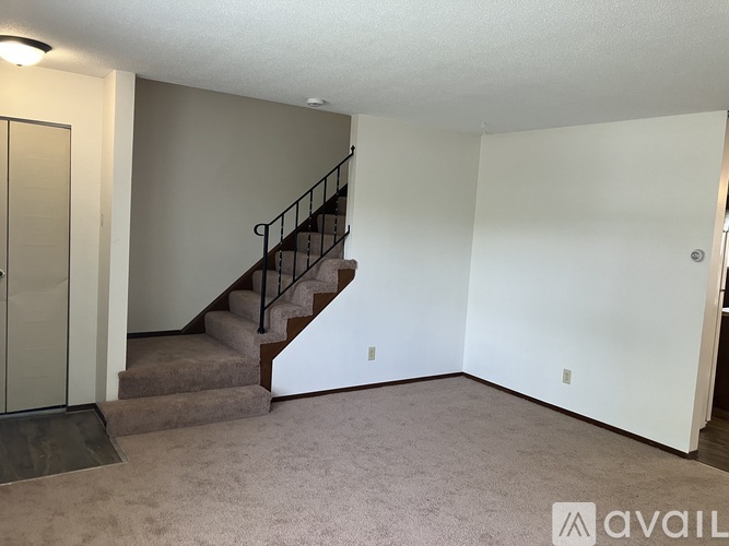 A room with a staircase and a door.
