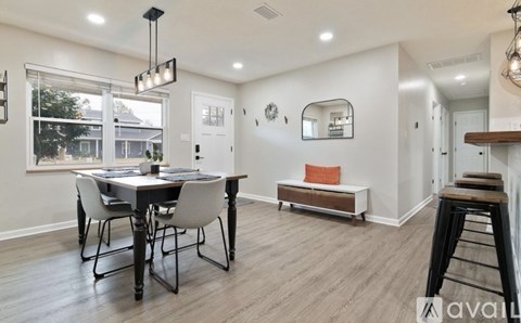 A dining room with a table and chairs.