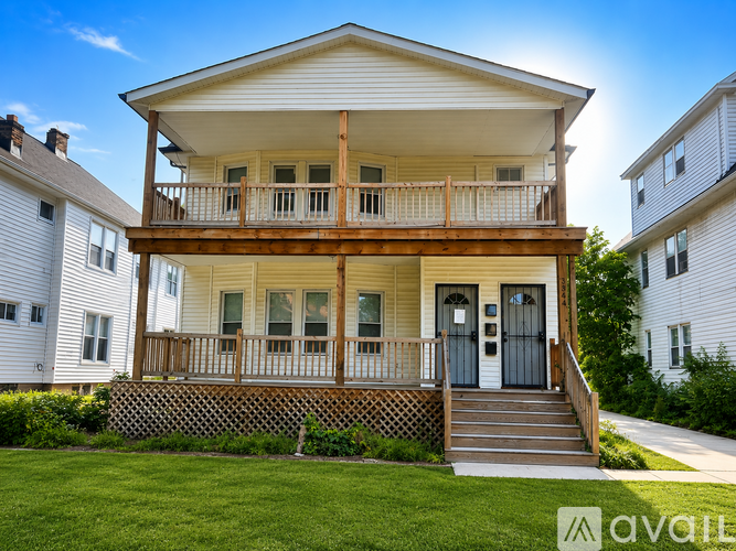 A wooden deck with a white house in the background.