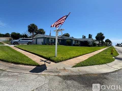 A house with a flag on a pole in front of it.