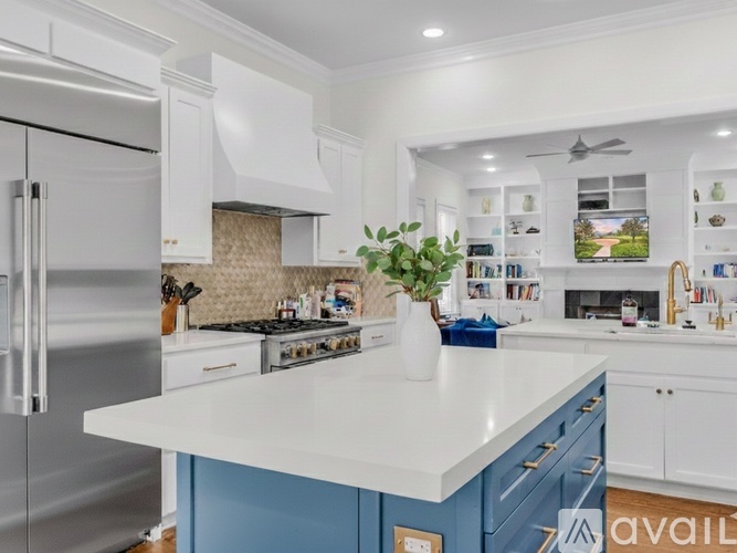 A kitchen with a white countertop and blue cabinets.